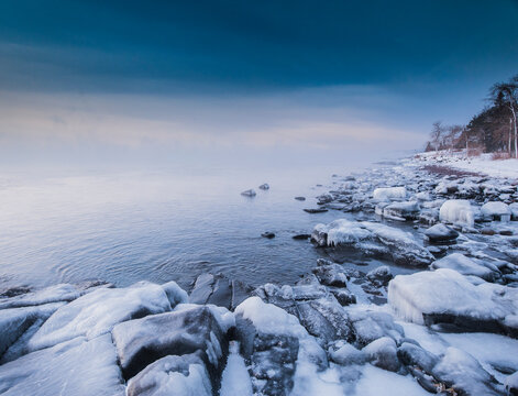 In winter the sun rose slowly over Lake Superior while the open water and -20 F degree air mixed, creating thick wisps of sea smoke. Brighton Beach, Duluth, MN.
