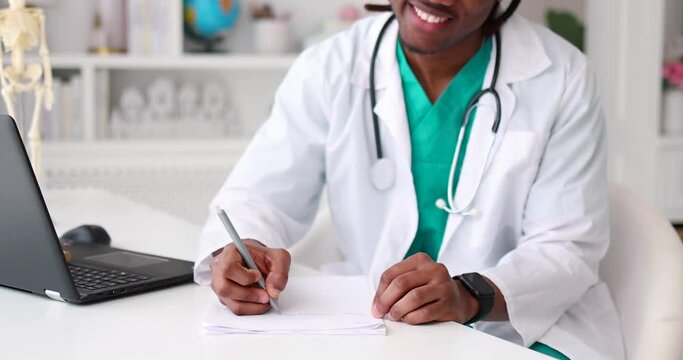 young african american doctor filling paper documentation
