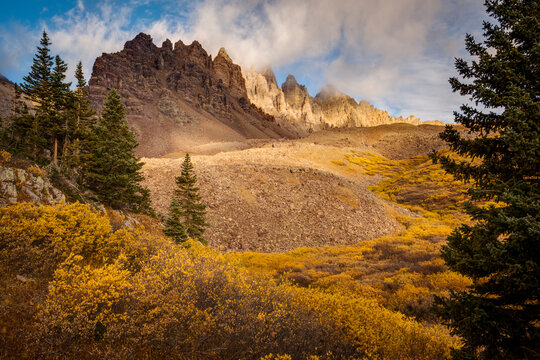 Early morning light on the jagged peaks above Cathedral Lake in fall. Aspen, Colorado.