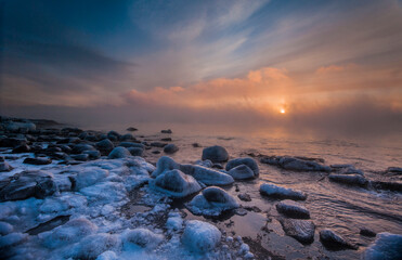 In winter the sun rose slowly over Lake Superior while the open water and -20 F degree air mixed, creating thick wisps of sea smoke. Brighton Beach, Duluth, MN.