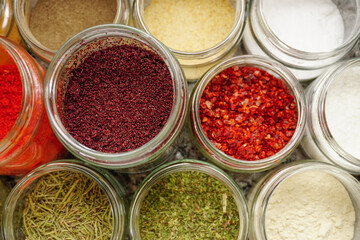 Assorted seasoning spice in the jars in the kitchen close up view
