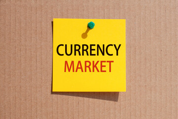 words currency market written on yellow square paper and pinned on craft paperboard
