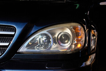 Fototapeta na wymiar Car headlights. Luxury Headlights. Car details. Part of a blue car