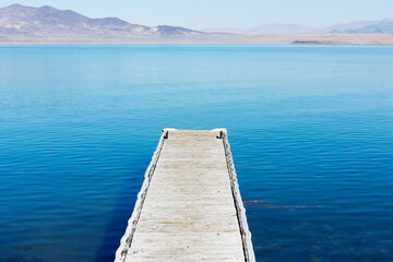 A wooden pier reaches out into Pyramid Lake, Great Basin in the northwestern part of Nevada, USA
