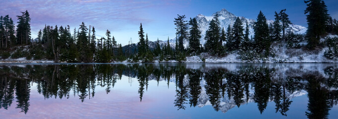 Mount Shuksan is reflected in a lake in late autumn near Mount Baker Ski Area.