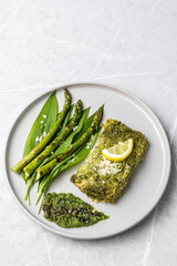 Salmon fillet with green wild garlic pesto. Green asparagus with salmon