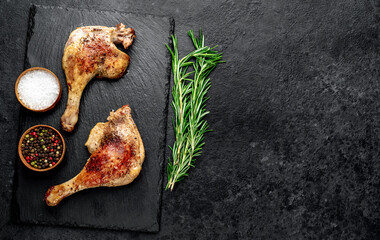 Roasted duck leg with spices on a stone background with copy space for your text