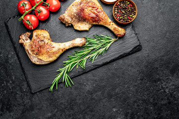 Roasted duck leg with spices on a stone background with copy space for your text
