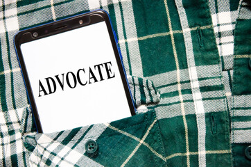 ADVOCATE the word is written on the white screen of the phone that lies in the shirt