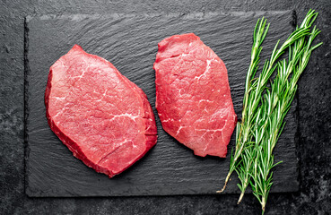 raw beef steak with spices on stone background