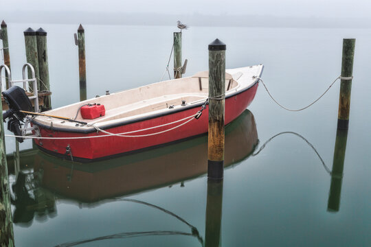 Small motorboat at a mooring in the fog