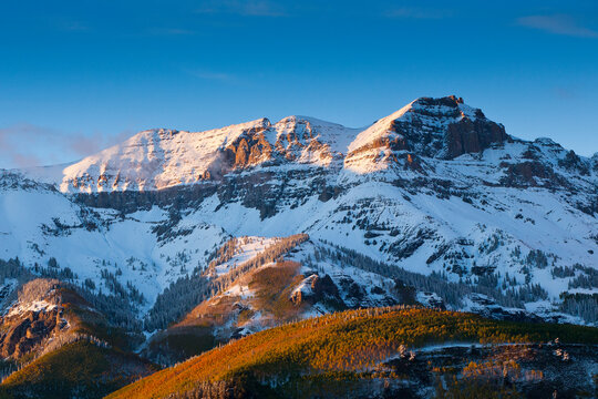 The last warm rays of sunset drape over the peaks in the San Juan mountains near Telluride, Colorado.