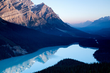 Calm blue water fills this glacially fed lake shaped like a wolf's head in Banff National Park, Alberta