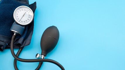 Blood pressure measuring device, cardiology and physical checkup concept with Sphygmomanometer isolated on blue background with copy space