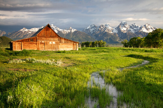 Scenic landscape image of the Moulton Barn with storm clouds, Grand Teton National Park, Wyoming.