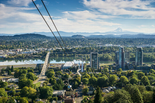 The ariel tram makes its way from campus to the city's waterfront below. Snow-capped Mount Hood can be seen in the distance.