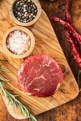 The raw beef meat steak on cutting board.