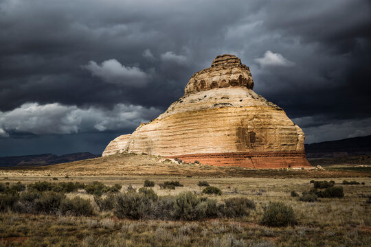 Church Rock, a sandstone formation in Monticello, Utah is painted with light during an on coming desert storm