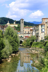 Fototapeta premium City view of Castelnuovo Garfagnana historical village and the river. View of the historic Tuscany town against the wonderful natural scenary of Garfagnana.