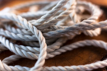 Close-up of an old shabby rope on a wooden background. 