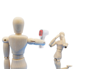 非接触式体温計で高熱があることが判明して悲観するデッサン人形
