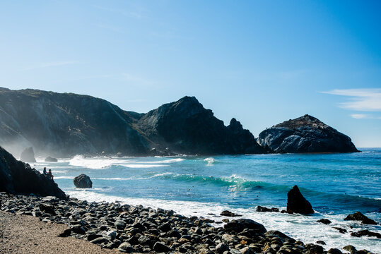 Waves roll ashore on the dramatic, rocky coast of the Willow Creek Picnic Area in Big Sur, CA.