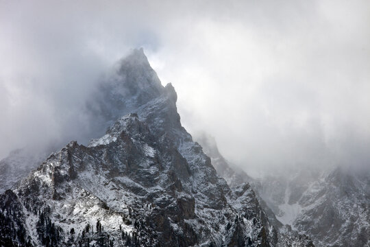 clouds and fresh snow on grand teton peaks