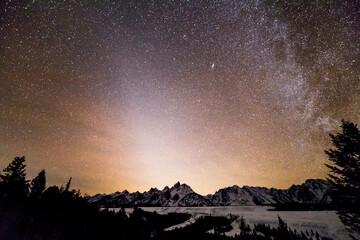 Zodiacal light shines above the Teton Mountains and the Snake River Overlook in Grand Teton National Park, Wyoming.