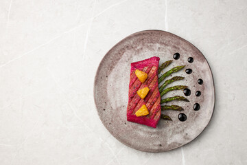 Beetroot marinated salmon with asparagus and pineapple.