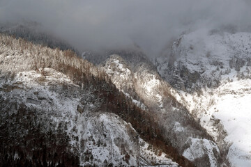 Swiss mountain covered with clouds landscape, early winter morning in Laax