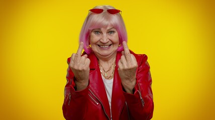 Aggressive crazy hooligan senior old rocker granny woman showing around her middle fingers, demonstrating protest with impolite rude gesture of disrespect, rejecting communication. Elderly grandmother