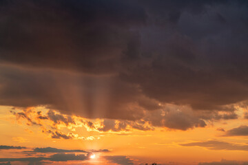 orange sunset sky with lighted clouds