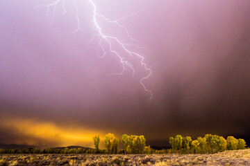 A lightning bolt strikes toward Jackson Hole, Wyoming during a storm.