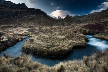 Pastel like colors during sunset of a windy small blue tributary near Lake Viconga with Mt Cuyoc in the background, located in the Cordillera Huayhuash in the Peruvian Andes Mountains.