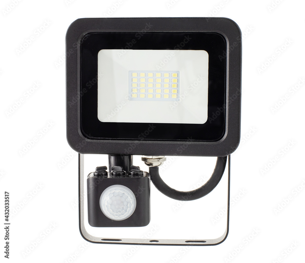 Sticker Motion sensor LED floodlight in hand on white background isolation.