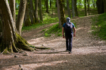 Man with backpack hiking in the forest