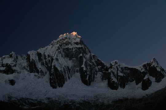 Sunset And The Last Sliver Of Light Upon Mt. Tralliraju In The Cordillera Blanca In The Andes Mountains Of Peru.