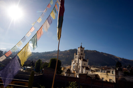 Rooftop prayer flags, Huaraz Peru. La Soledad church behind.