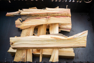 Dry wood in the grill for kindling and making coals