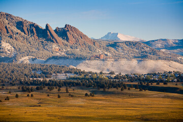 The Flat Irons rock escarpments rise above Boulder, Colorado and the snow-covered summit of Mt. Long's Peak are seen further north in early Spring.