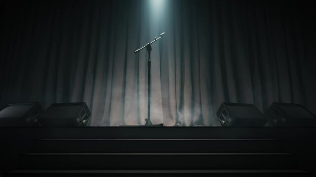Stand with microphone on empty stage. Microphone stands on an empty stage in the dark