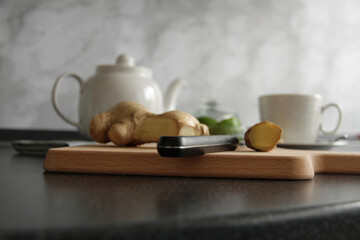 Making green tea with lime and ginger for breakfast, horizontal