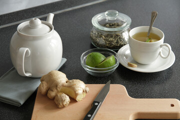 Making green tea with lime and ginger for breakfast, horizontal