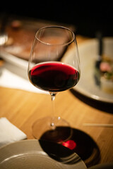 a glass of red wine on the table
