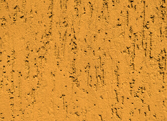 Orange texture of decorative plaster with imitation of bark beetle. Abstract background.