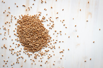 pile of buckwheat grains on a white background from above with copy space