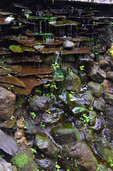 Water flows from a wall of stone piles