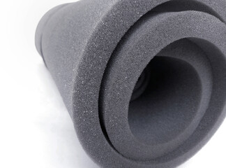 one roll of black sponge foam insulated on a white background