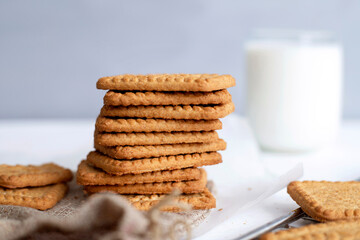 Fototapeta na wymiar Biscuits with milk on wood background in the morning