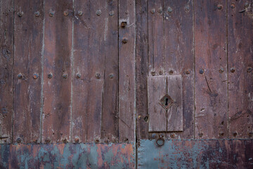 antique brown wooden door with an handle and a lock